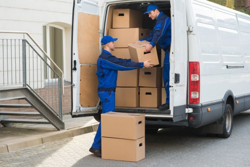 Prepared boxes and furniture ready for a Crewshill moving van