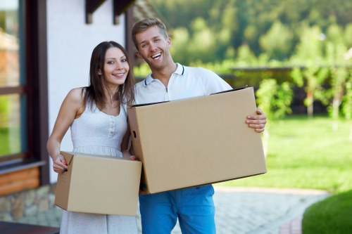 Professional movers handling furniture in a Crewshill home