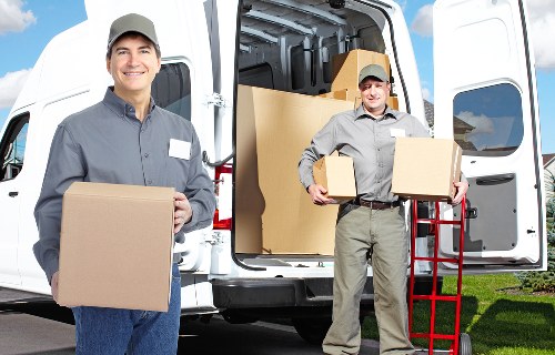 Removal team carrying furniture carefully through a home entrance